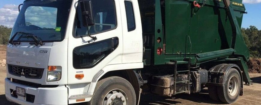 Truck With A Green Skip Bin